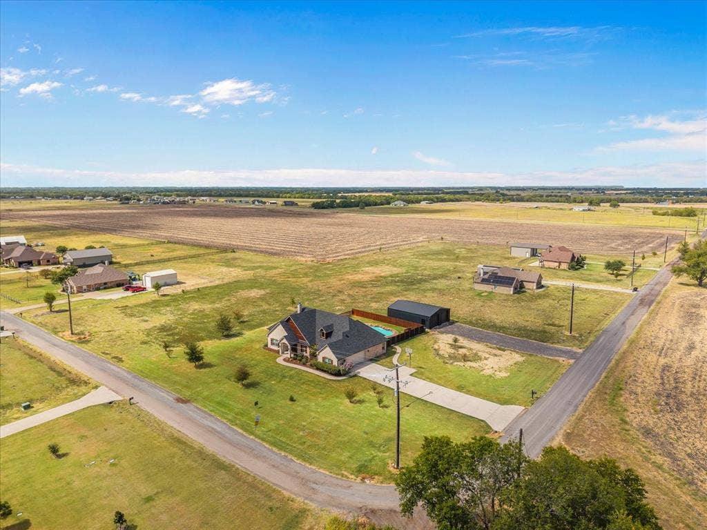 3674 County Road 2142, Caddo Mills, TX 75135 Single-story residence featuring a dark shingle roof, light-toned exterior siding, and an attached garage