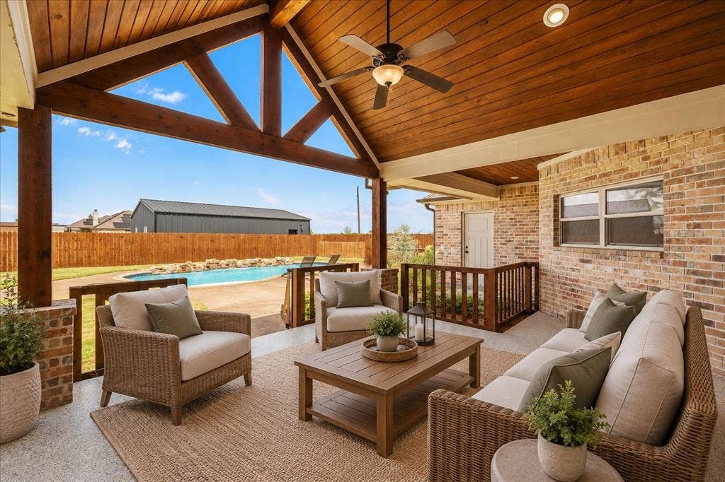 3674 County Road 2142, Caddo Mills, TX 75135 Covered patio featuring an exposed wood beam ceiling, ceiling fan, and brick exterior