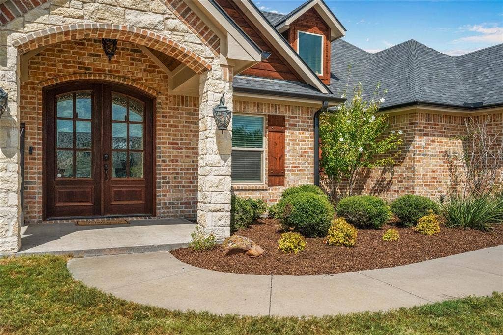 3674 County Road 2142, Caddo Mills, TX 75135 Brick and stone exterior with a gabled roofline