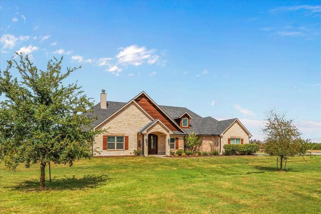 3674 County Road 2142, Caddo Mills, TX 75135 Stone and wood-sided exterior with a gabled roofline