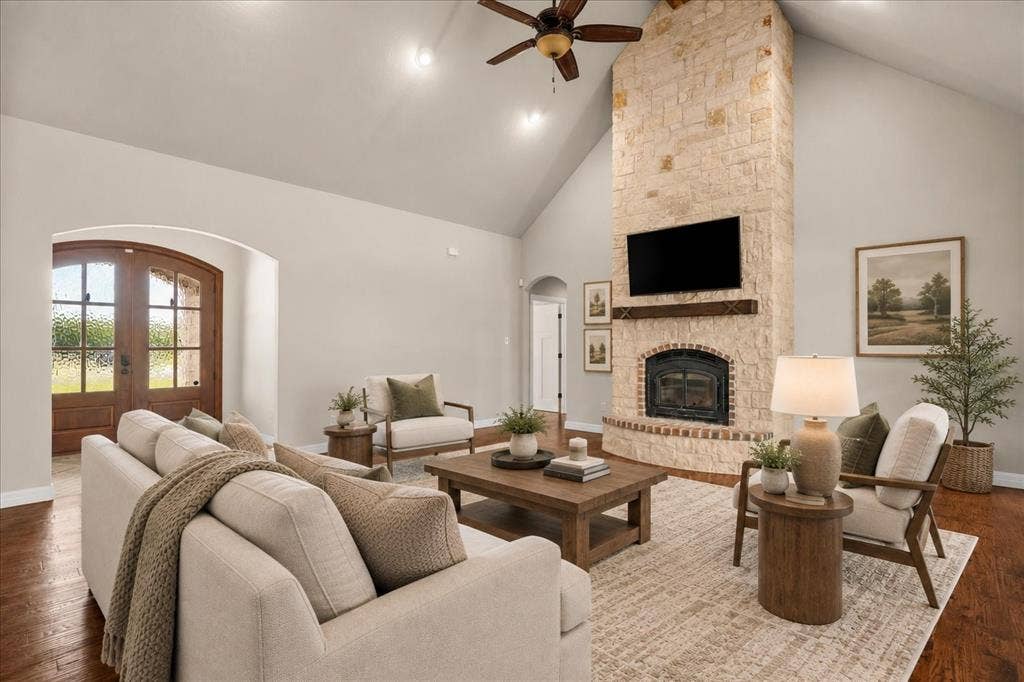 3674 County Road 2142, Caddo Mills, TX 75135 Vaulted ceilings, a stone fireplace with a wood-finish mantel, and wood-finish flooring