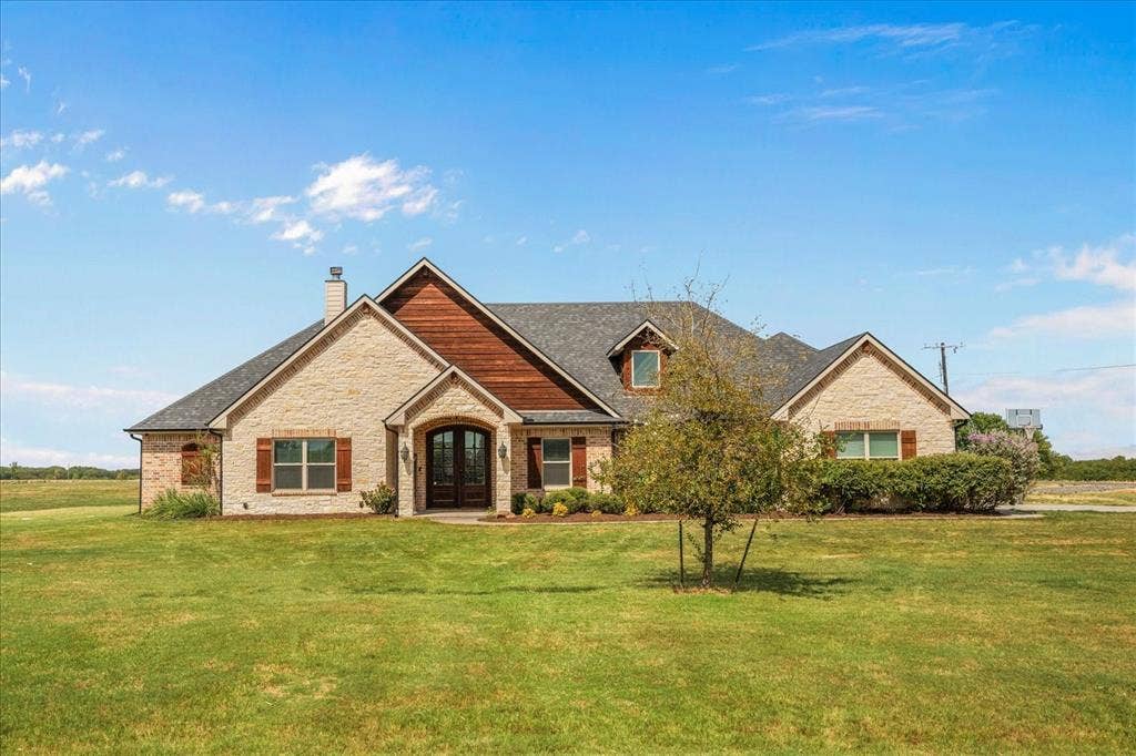 3674 County Road 2142, Caddo Mills, TX 75135 Brick and wood-sided exterior with a gabled roofline