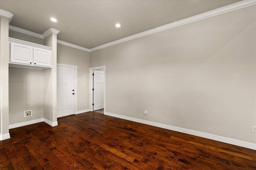 3674 County Road 2142, Caddo Mills, TX 75135 Hardwood flooring, crown molding, recessed lighting, white built-in cabinetry, and white paneled doors