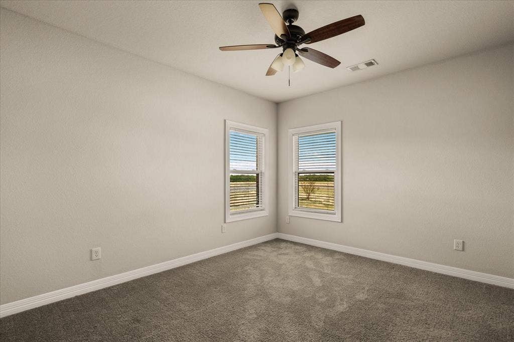 3674 County Road 2142, Caddo Mills, TX 75135 Recessed windows with blinds, ceiling fan with light fixture, neutral wall color, and carpeted flooring