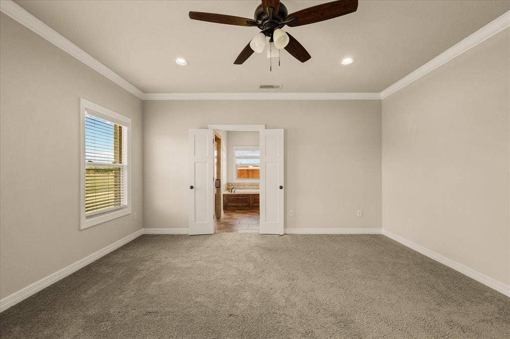 3674 County Road 2142, Caddo Mills, TX 75135 Spacious room featuring neutral carpeting, a ceiling fan, recessed lighting, and crown molding