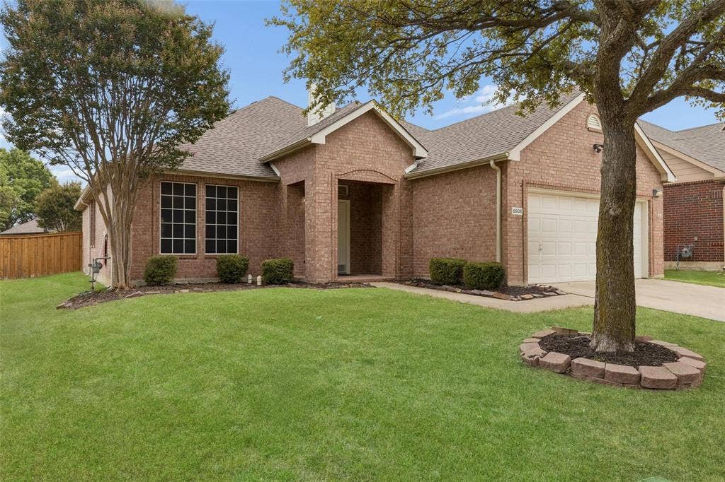 6508 Courtyards Drive, McKinney, TX 75072 Brick exterior with an attached garage, covered entry, and large front windows
