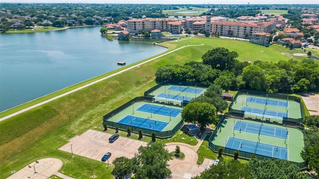 6508 Courtyards Drive, McKinney, TX 75072 Lakeside community with multiple tennis courts, a paved walking path, and a manicured green space
