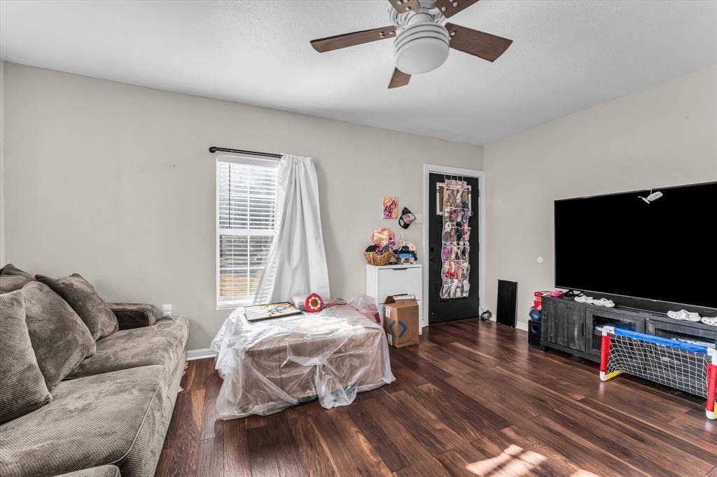 3605 Rolando Avenue, Waco, TX 76711 Wood-finish flooring, ceiling fan with integrated lighting, natural light from the window, and a solid-panel door