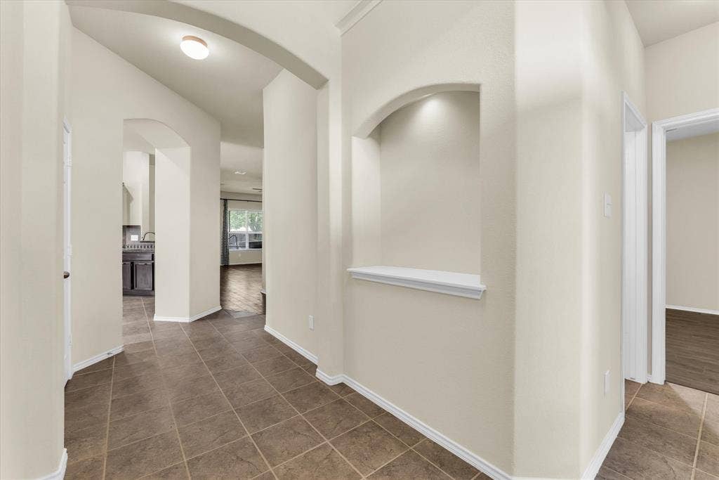 6621 Burling Street, Waco, TX 76712 Arched wall openings, recessed wall niche with accent lighting, tile flooring, and light wall finishes