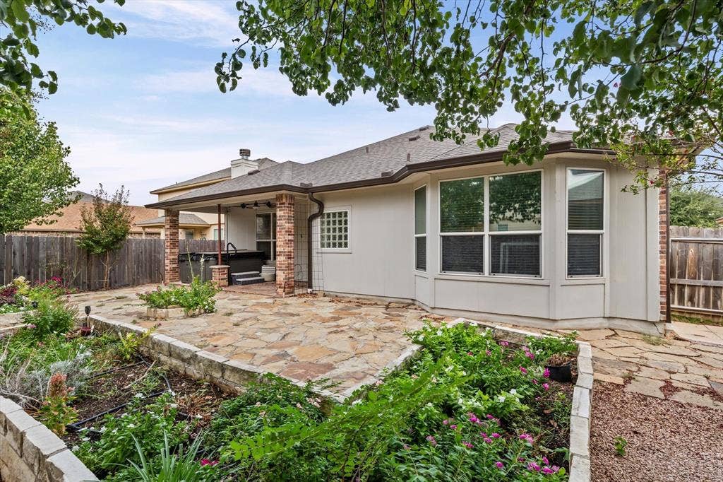 6621 Burling Street, Waco, TX 76712 Expansive flagstone patio with a covered outdoor area, brick columns, and a built-in spa