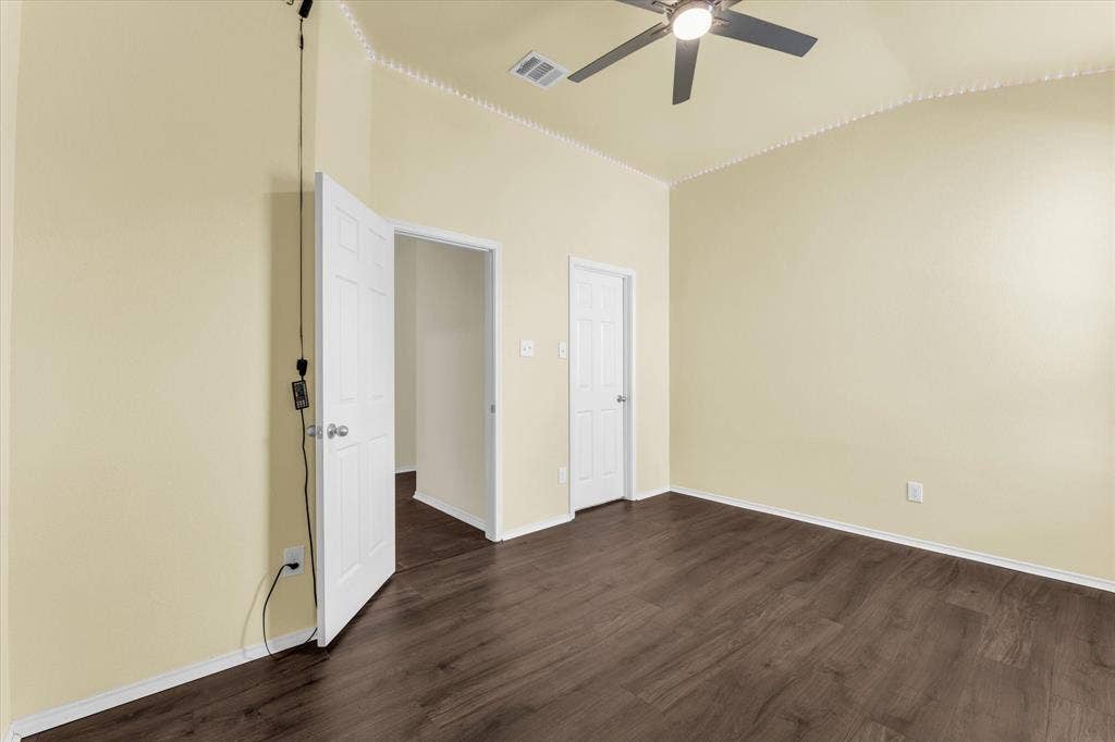 6621 Burling Street, Waco, TX 76712 Vaulted ceiling, wood-finish flooring, ceiling fan with integrated lighting, crown molding, and paneled doors