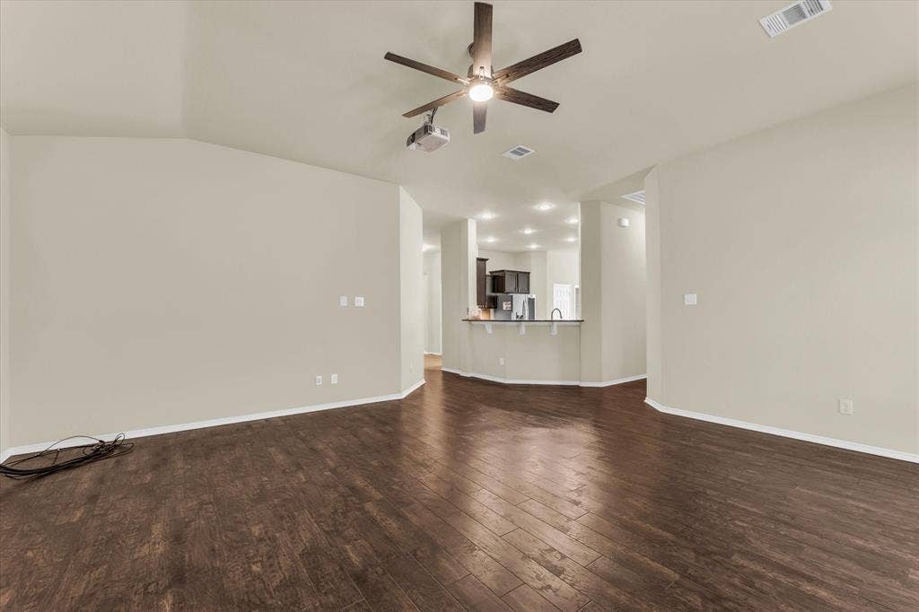 6621 Burling Street, Waco, TX 76712 Vaulted ceiling with a ceiling fan, wood-finish flooring, and recessed lighting in the kitchen area