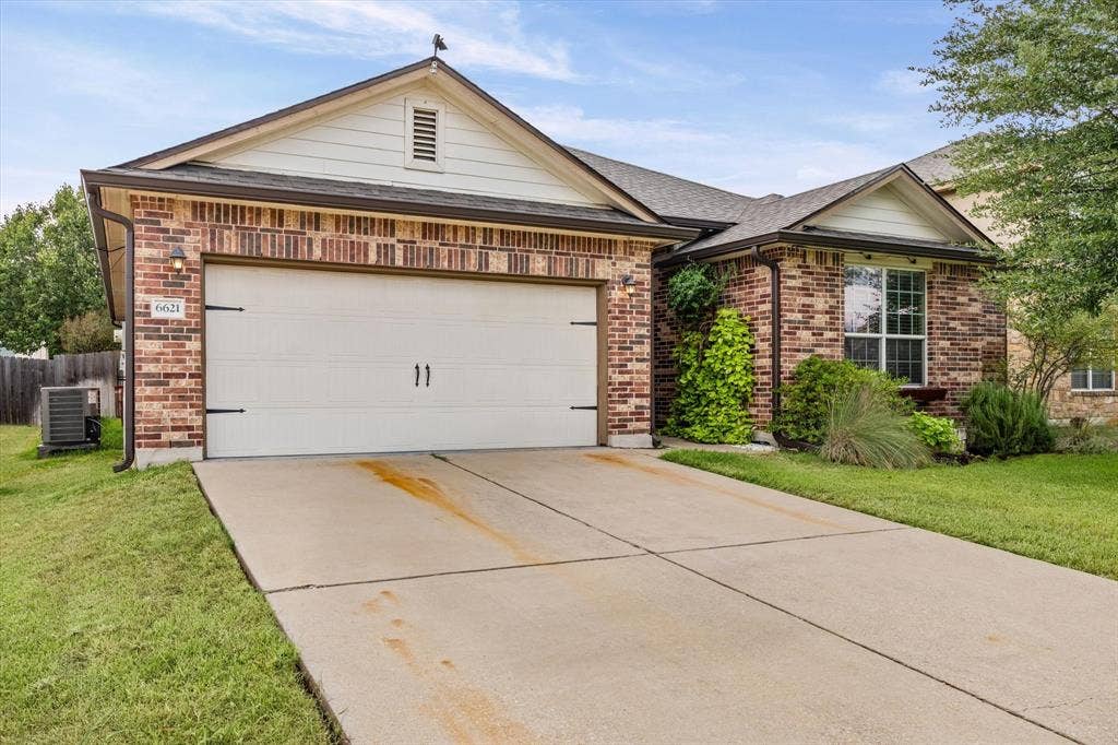 6621 Burling Street, Waco, TX 76712 Brick exterior with a gabled roofline, a two-car garage, and landscaped front yard