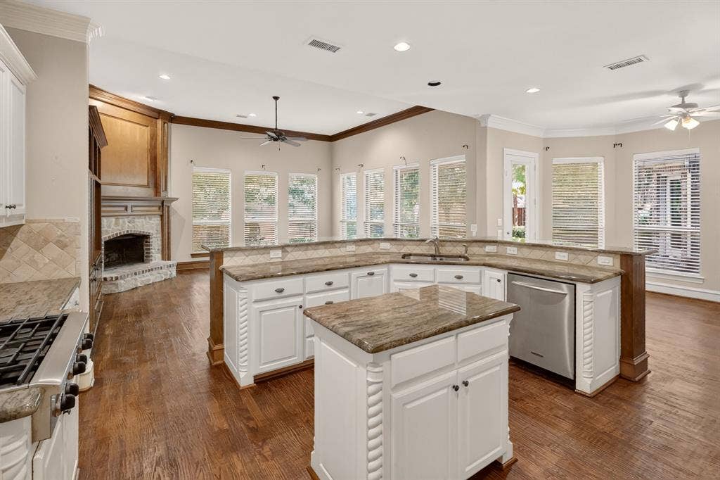 112 Winsley Circle, McKinney, TX 75071 Island kitchen, wood flooring, overlooks family room, breakfast area and water view.