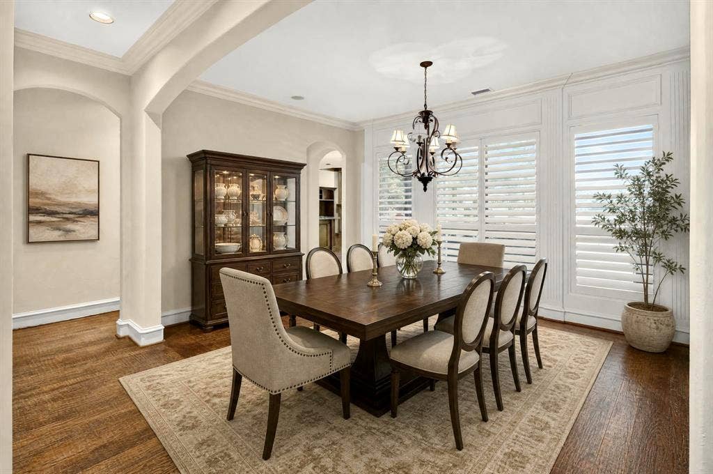 112 Winsley Circle, McKinney, TX 75071 Virtually staged formal dining with archways and wood flooring complement the white paneled walls and plantation shutters. Water View