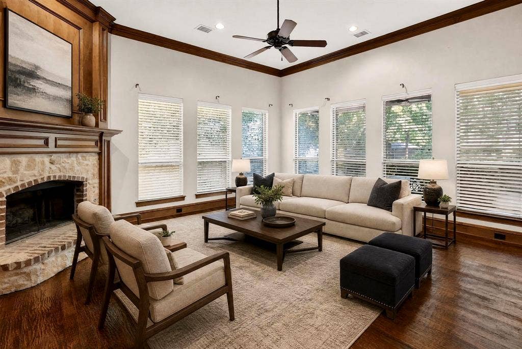112 Winsley Circle, McKinney, TX 75071 Virtually staged family room with second fireplace, wood mantle, recessed lighting, rich wood flooring, and multiple windows with blinds. Gorgeous water views.