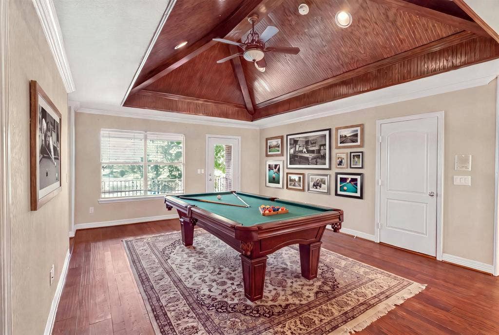 112 Winsley Circle, McKinney, TX 75071 Virtually staged game room with vaulted wood-paneled ceiling wood-finish flooring, and recessed lighting. Balcony with water views.