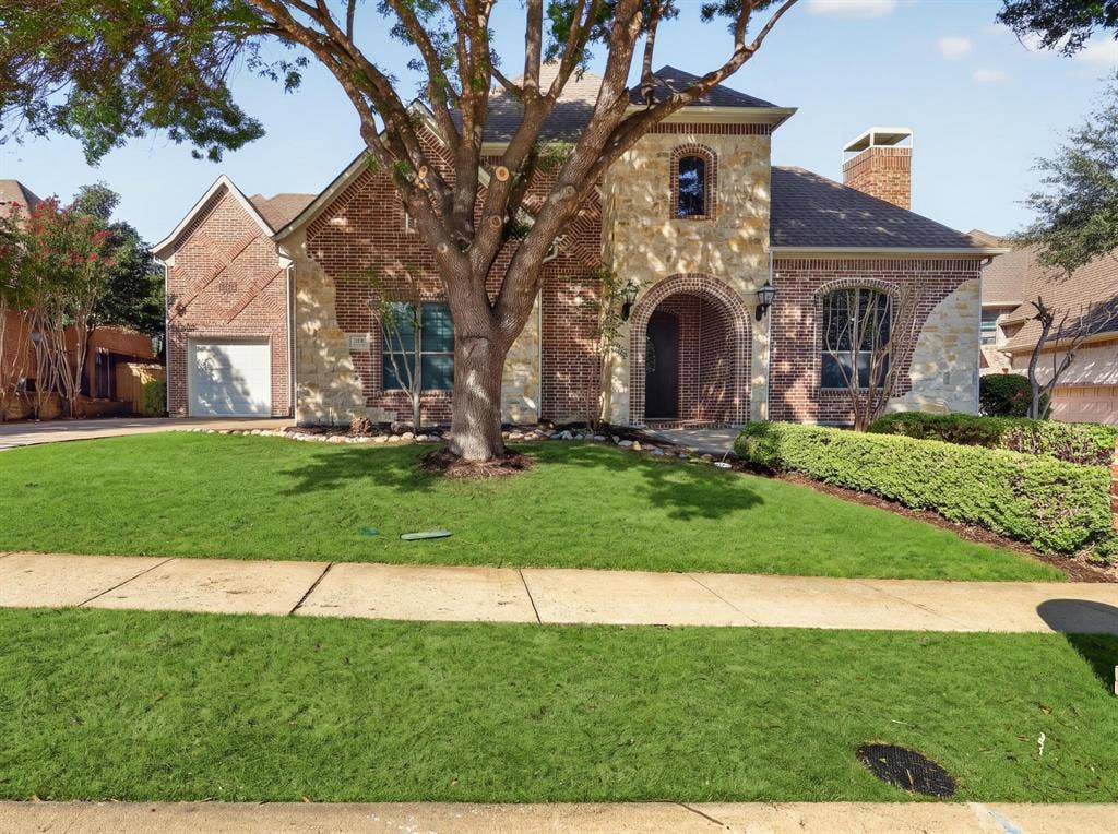 112 Winsley Circle, McKinney, TX 75071 Brick and stone exterior with an arched entryway, and integrated 3 garage garage