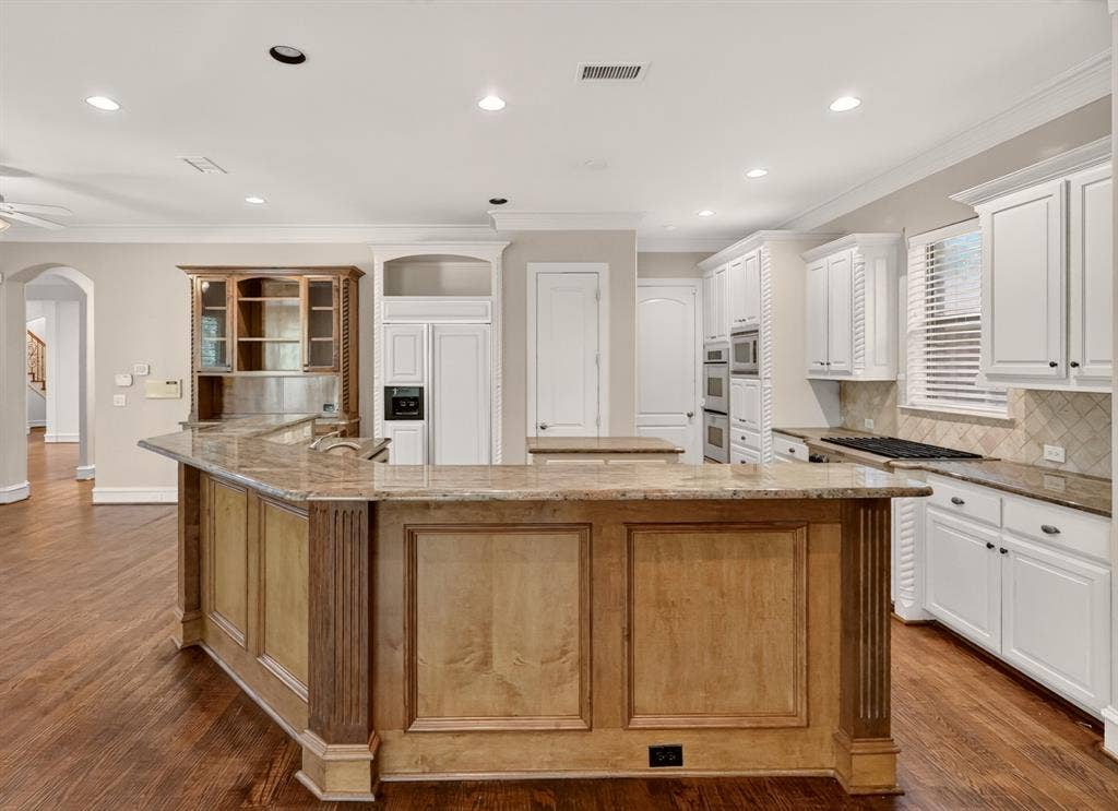 112 Winsley Circle, McKinney, TX 75071 island kitchen, granite counters, double ovens, wood flooring and walk in pantry