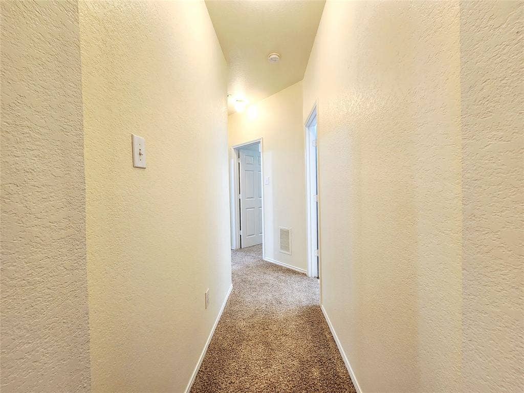 10307 Asheboro Street, Frisco, TX 75035 Carpeted hallway with textured wall finish and recessed lighting