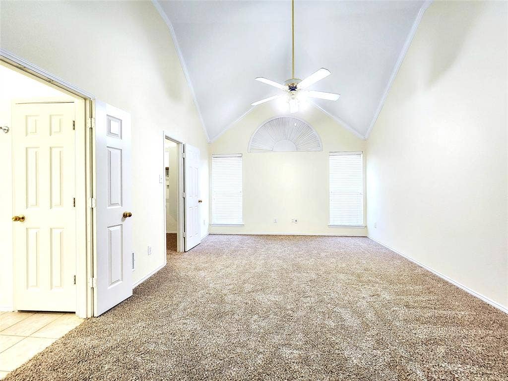 10307 Asheboro Street, Frisco, TX 75035 Vaulted ceiling featuring a ceiling fan, arched transom window, and two rectangular windows with blinds
