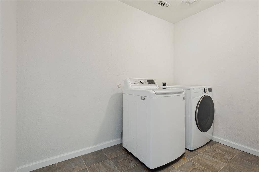 2405 Collier Drive, McKinney, TX 75071 Laundry area featuring tiled flooring and white walls