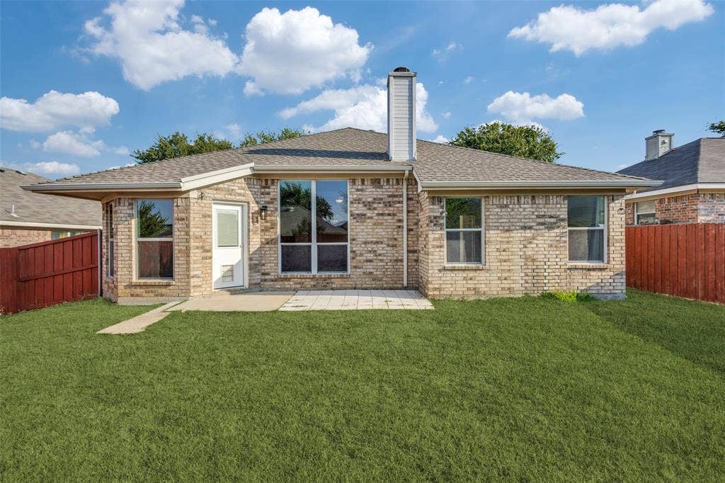 2405 Collier Drive, McKinney, TX 75071 Expansive green lawn with a patio area, brick exterior, and multiple windows
