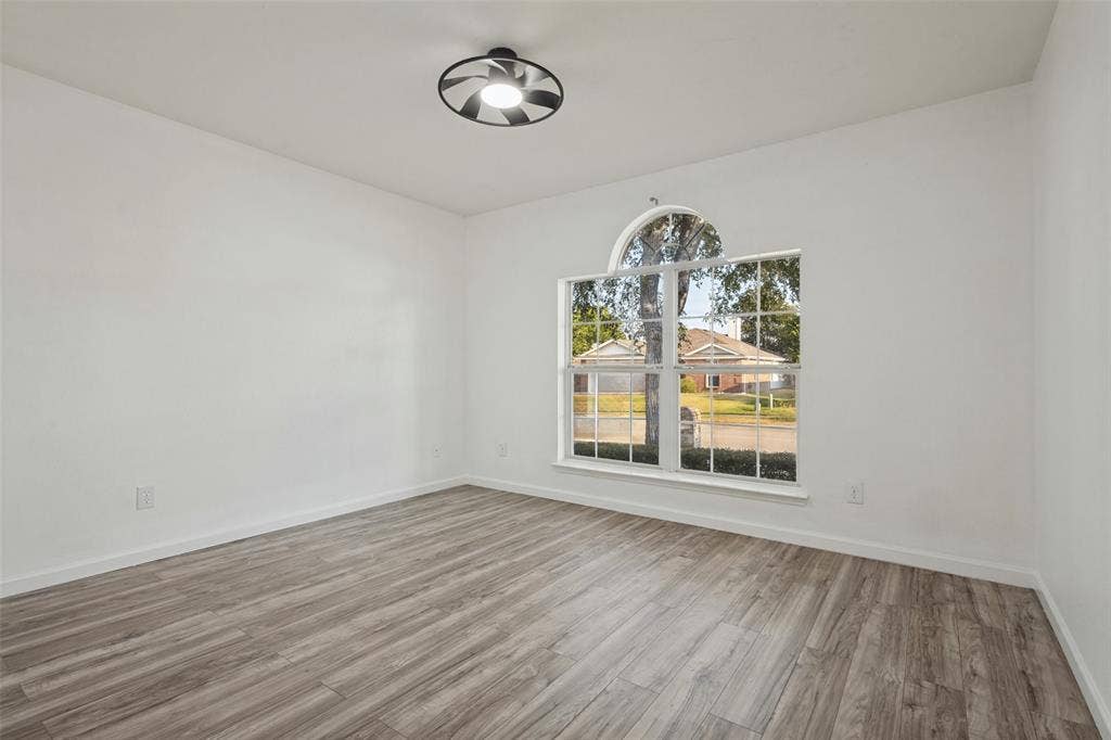 2405 Collier Drive, McKinney, TX 75071 Wood-finish flooring, white walls, and a contemporary ceiling light fixture