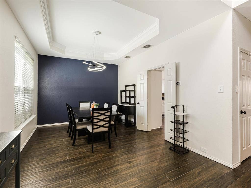 1206 Bel Air Drive, Allen, TX 75013 Tray ceiling with crown molding, contemporary chandelier, wood-finish flooring, and white interior doors