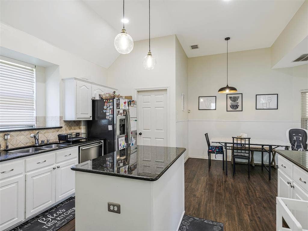 1206 Bel Air Drive, Allen, TX 75013 Kitchen featuring white cabinetry, dark countertops, wood-finish flooring, a center island, and a tile backsplash