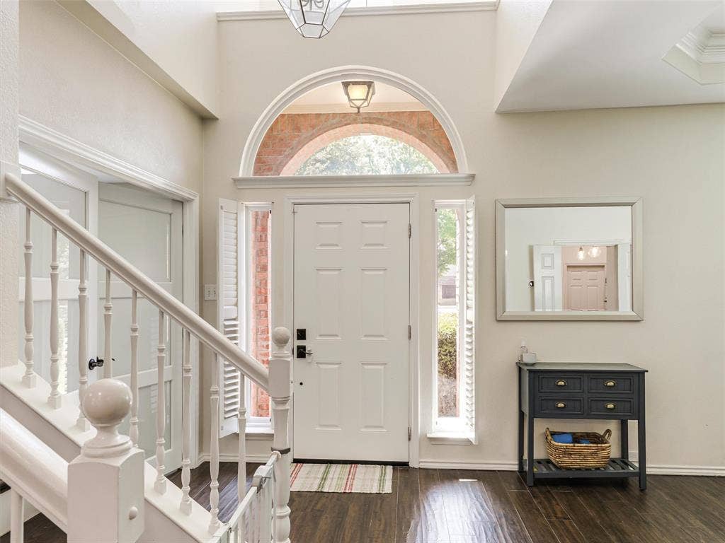 1206 Bel Air Drive, Allen, TX 75013 Two-story foyer with high ceilings, dark wood-finish flooring, and white painted balusters