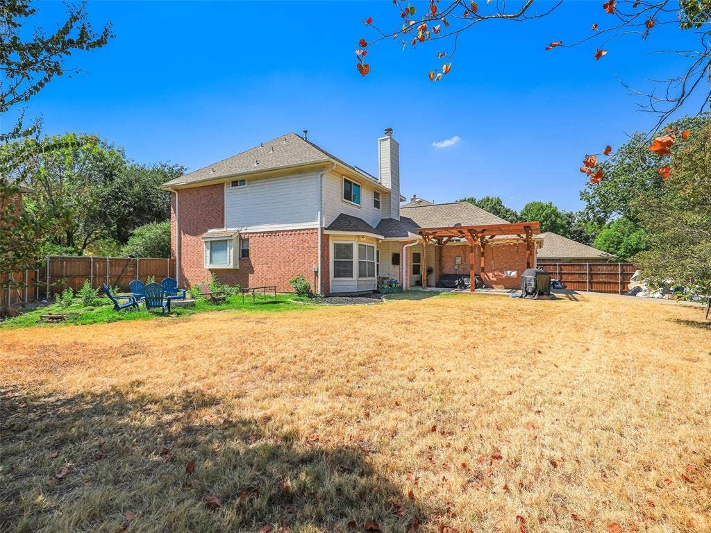 1206 Bel Air Drive, Allen, TX 75013 Expansive backyard featuring a wood pergola over a paved patio, a bay window, and a privacy fence