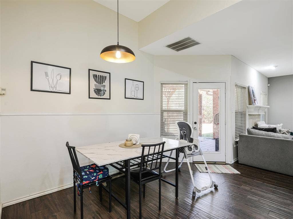 1206 Bel Air Drive, Allen, TX 75013 Dining area with wood-finish flooring, a contemporary pendant light fixture, and a glass-paneled door