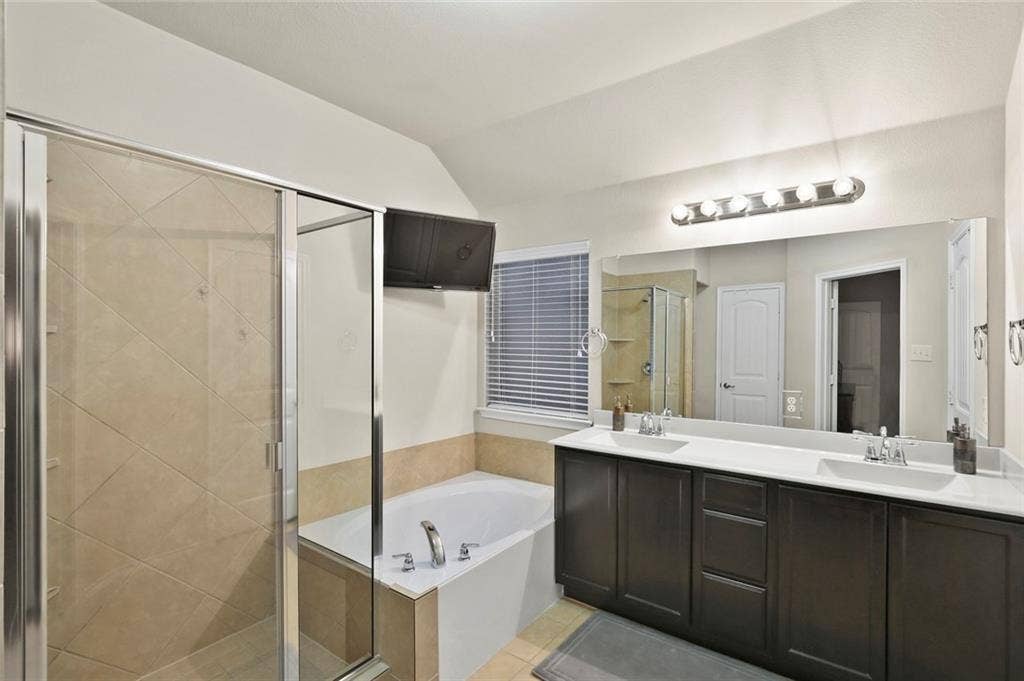 9609 Sand Trap Drive, McKinney, TX 75072 Dual vanity with undermount sinks, integrated countertop, and dark wood-finish cabinetry