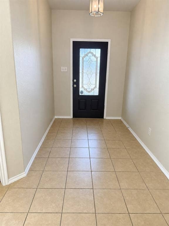 9609 Sand Trap Drive, McKinney, TX 75072 Entryway with ceramic tile flooring, a black paneled door featuring decorative glass, and a flush mount ceiling light