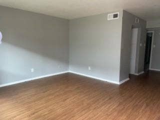 2200 W Lowden Street, #22, Fort Worth, TX 76110 Wood-finish flooring with white trim, light gray painted walls, and white ceilings