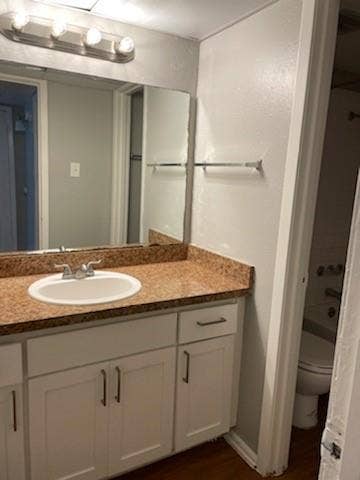 2200 W Lowden Street, #22, Fort Worth, TX 76110 Vanity with white shaker-style cabinetry, granite-look countertop, and an undermount sink
