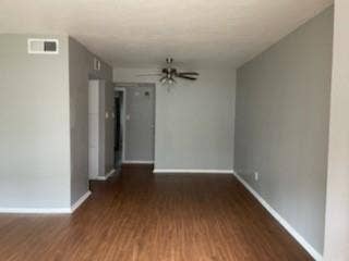 2200 W Lowden Street, #22, Fort Worth, TX 76110 Wood-finish flooring, neutral gray wall tones, white trim, and a ceiling fan