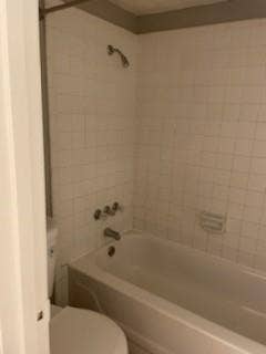 2200 W Lowden Street, #22, Fort Worth, TX 76110 White tile shower surround with a built-in tub and shower fixture
