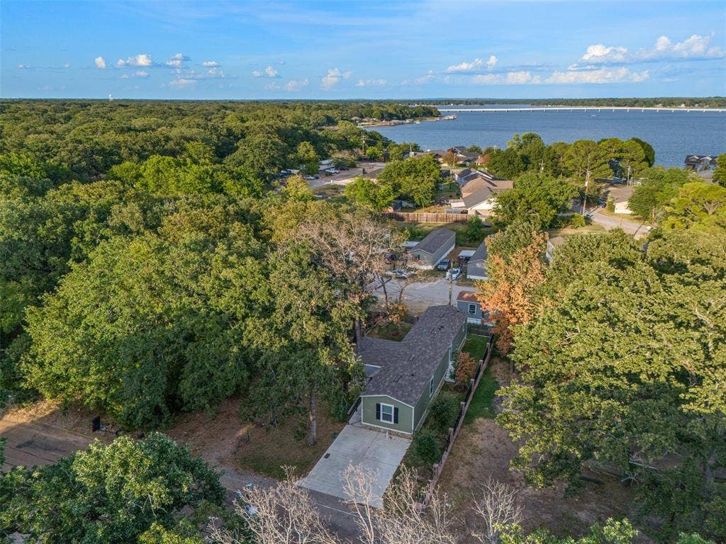 140 Southlake Drive, Mabank, TX 75156 Waterfront community setting with mature trees and a paved driveway
