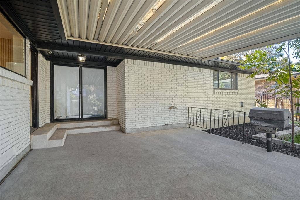 5021 Ashbrook Road, Dallas, TX 75227 Patio featuring a covered area, concrete flooring, and sliding glass doors