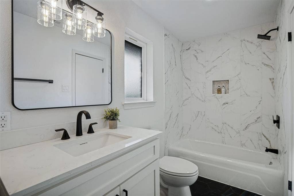 5021 Ashbrook Road, Dallas, TX 75227 White vanity with a quartz countertop and matte black fixtures