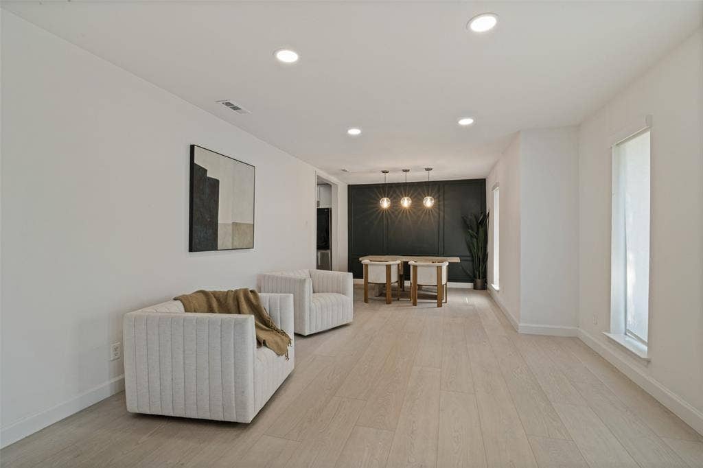 5021 Ashbrook Road, Dallas, TX 75227 Recessed ceiling lighting, wood-finish flooring, white painted walls, and window openings