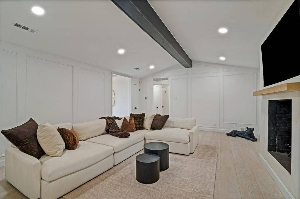 5021 Ashbrook Road, Dallas, TX 75227 Living area featuring light wood-finish flooring, recessed lighting, and a fireplace with a light wood mantel