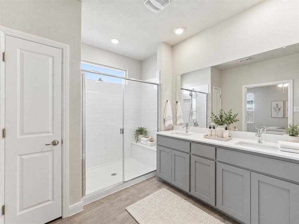 Dual vanity with quartz-finish countertops and undermount sinks