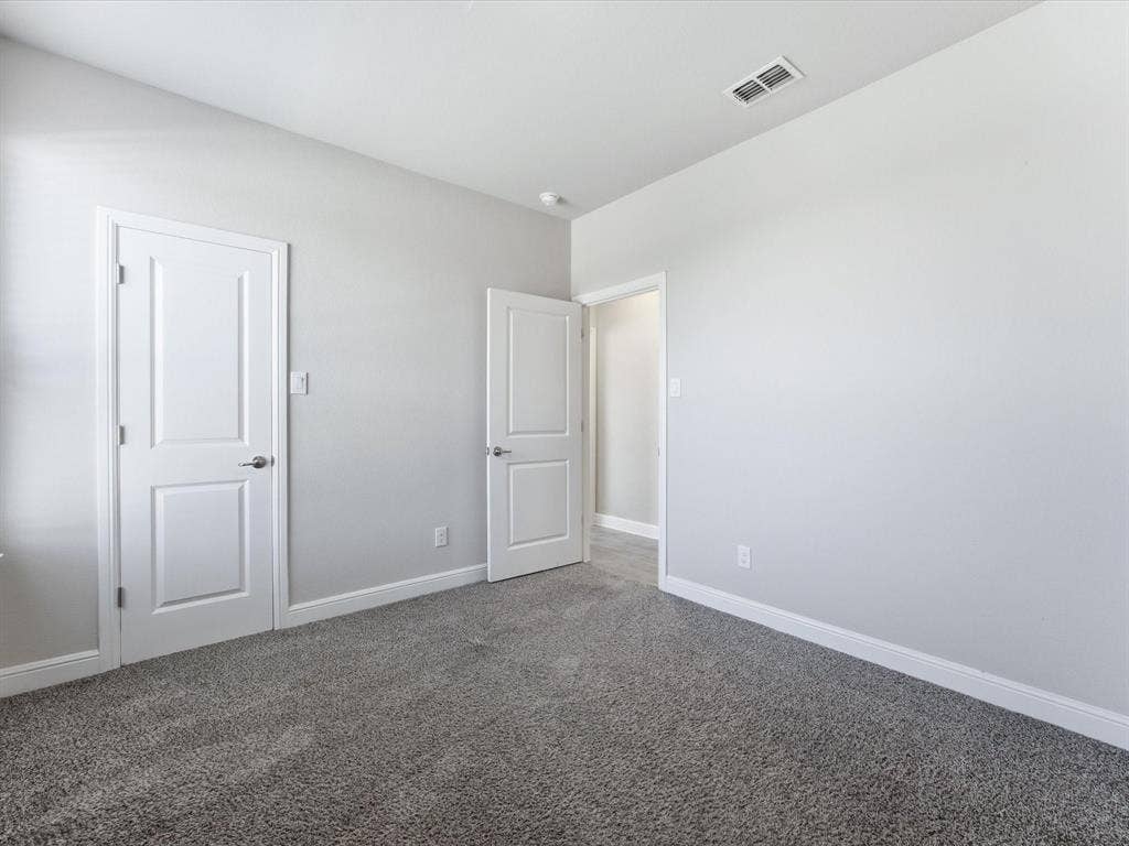 Gray textured carpeting and light gray wall paint