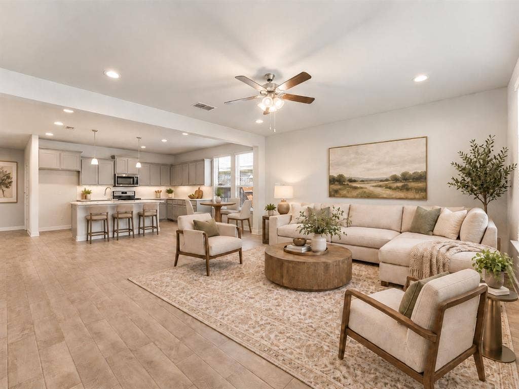 Open-concept living space featuring wood-finish flooring, recessed lighting, and a ceiling fan