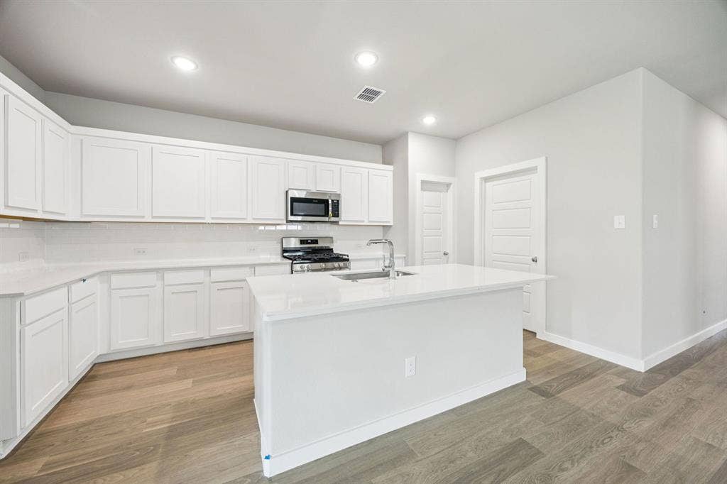 Kitchen in the Hayden home plan by Trophy Signature Homes – REPRESENTATIVE PHOTO
