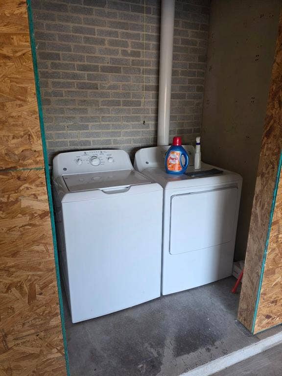 1608 University Drive, Richardson, TX 75081 Washroom with washing machine and dryer and laundry area