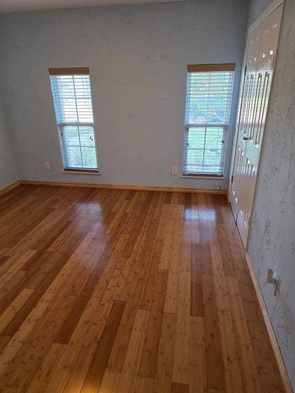 1608 University Drive, Richardson, TX 75081 Empty room with light wood-style flooring and baseboards